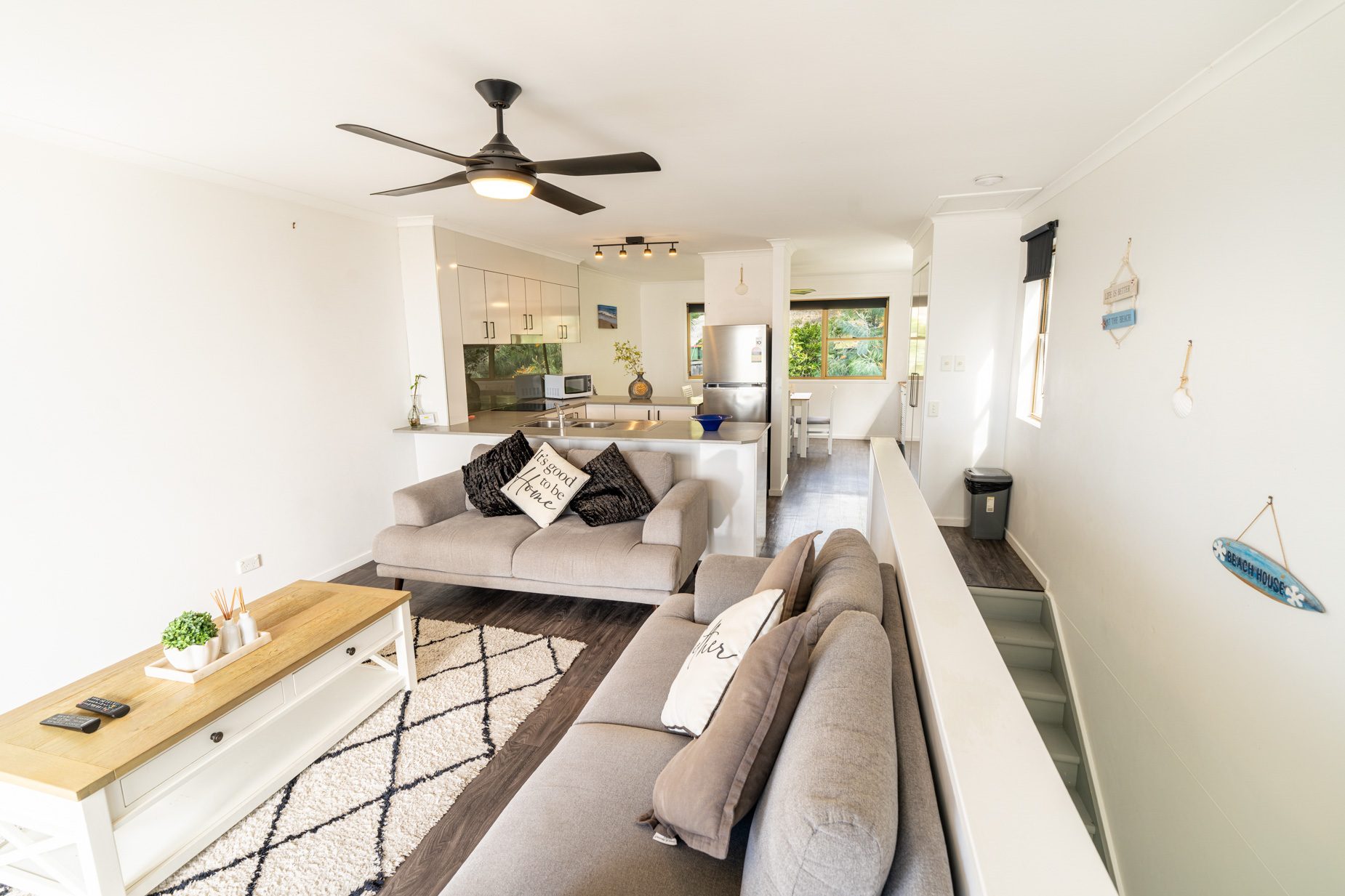 Open plan living room and kitchen inside a Standard Ocean villa at Pandanus Palms Resort