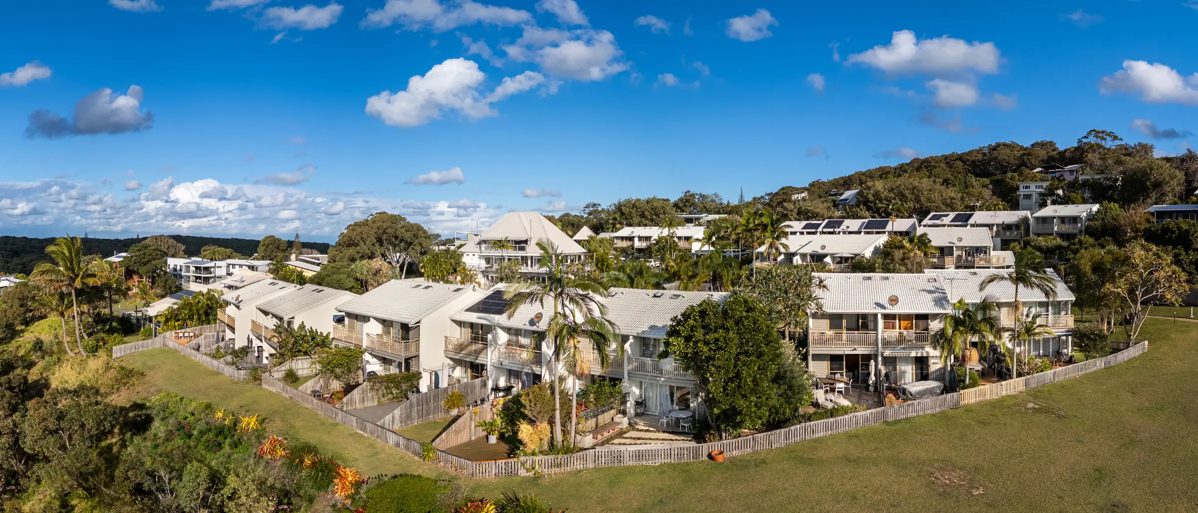 Two storey villas at Pandanus Palms Resort with balconies looking out over the open headland reserve lawn