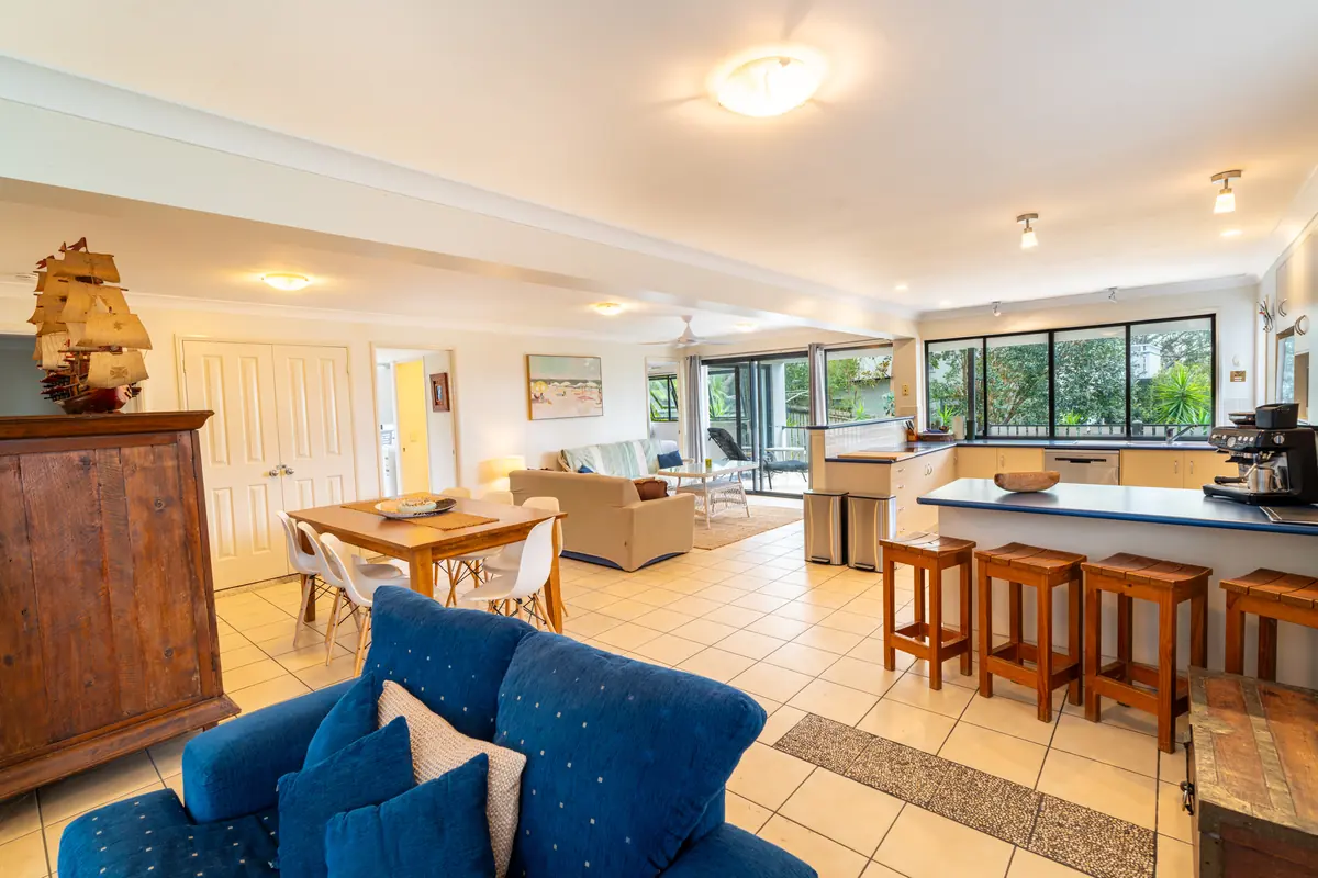The open plan living, dining and kitchen area of the three bedroom apartment at 8th on Roseby