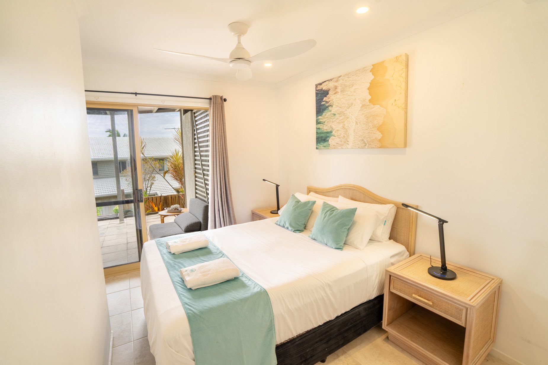 A queen bedroom with sliding doors to the balcony in the Standard Headland Ocean 3 Bedroom villa