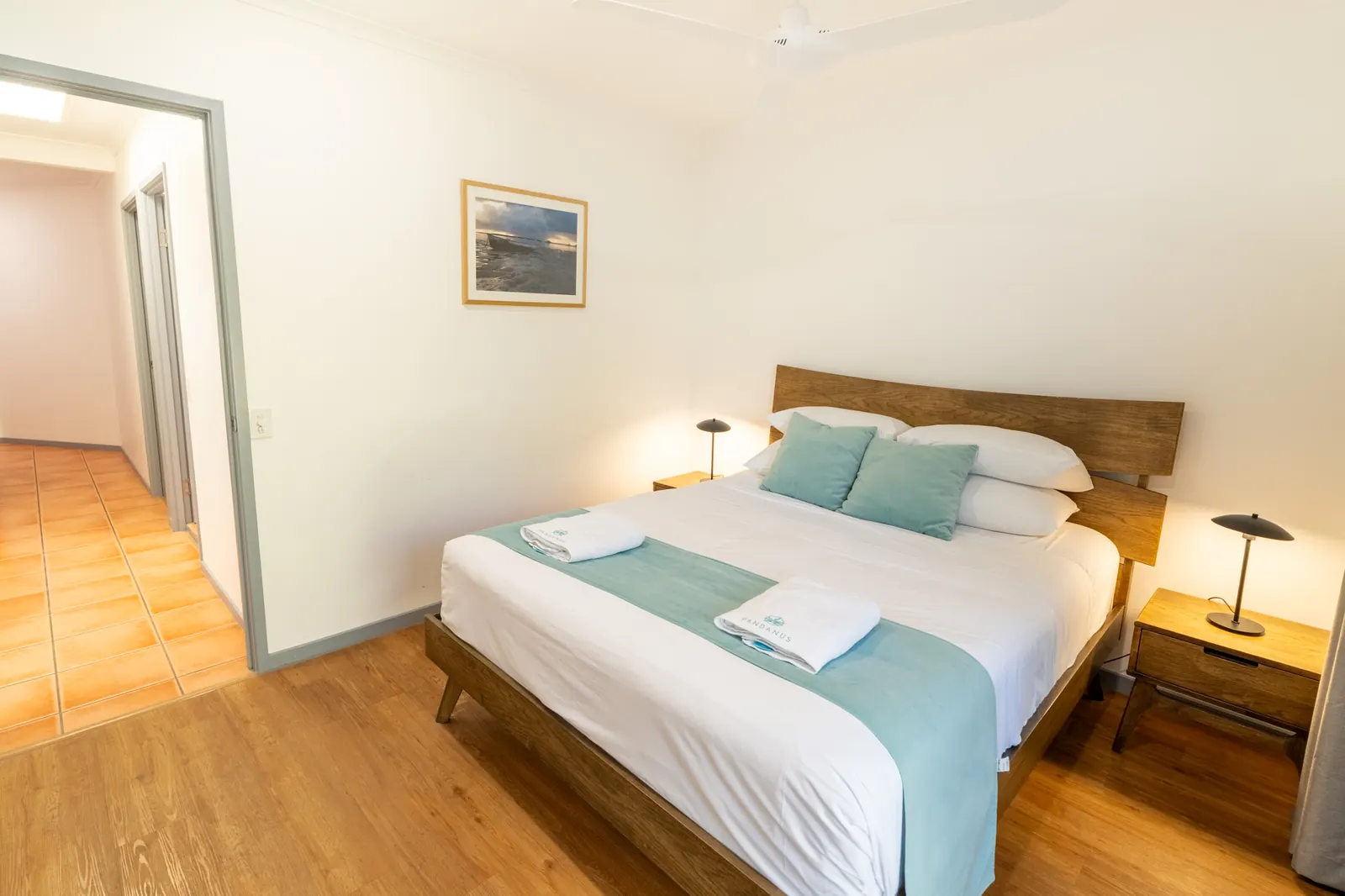A bedroom inside a Deluxe Ocean villa at Pandanus Palms Resort