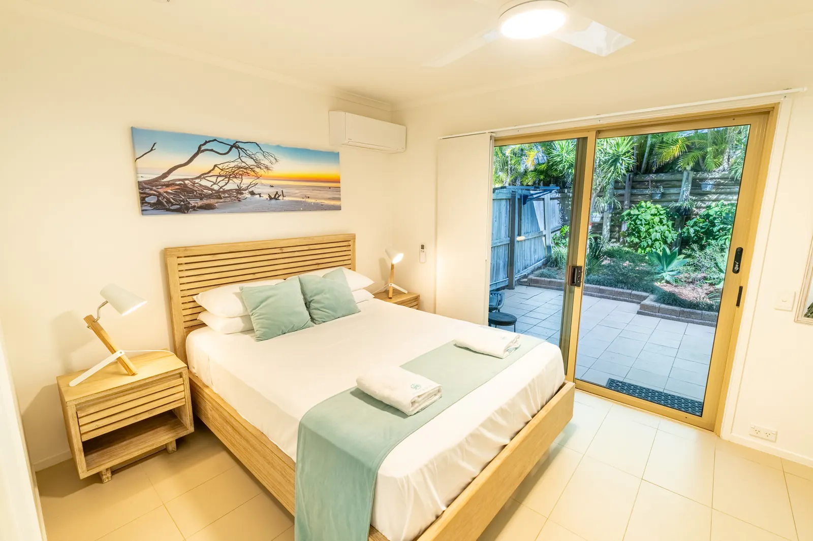 A bedroom inside a Deluxe Ocean villa at Pandanus Palms Resort