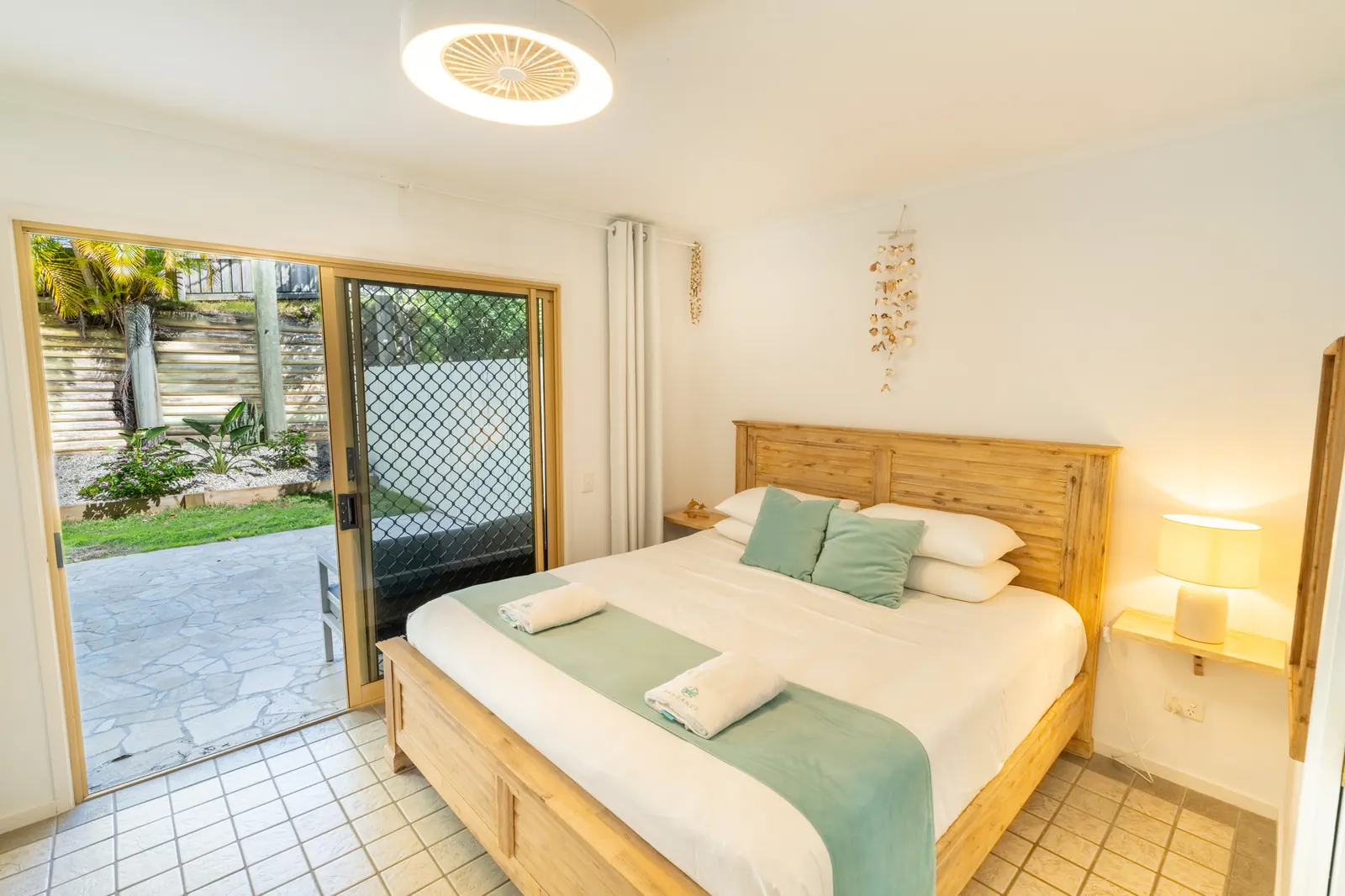 A bedroom inside a Deluxe Ocean villa at Pandanus Palms Resort