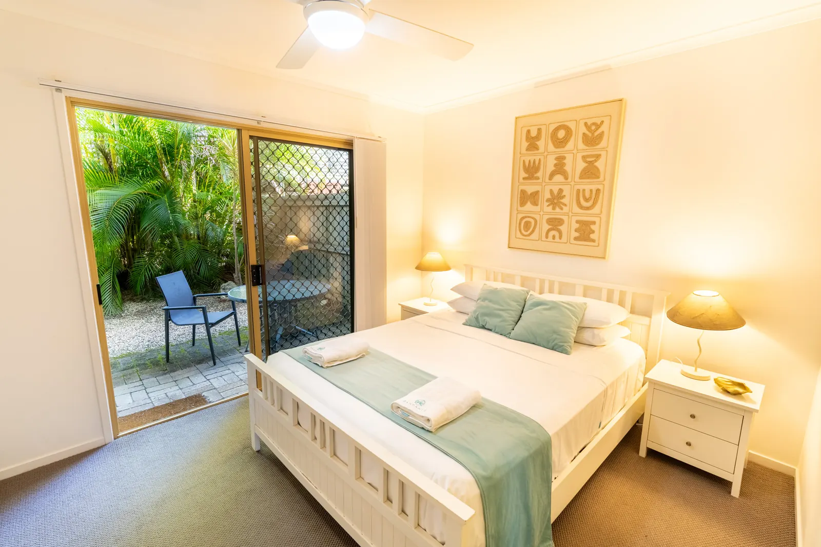 A bedroom inside a Deluxe Ocean villa at Pandanus Palms Resort
