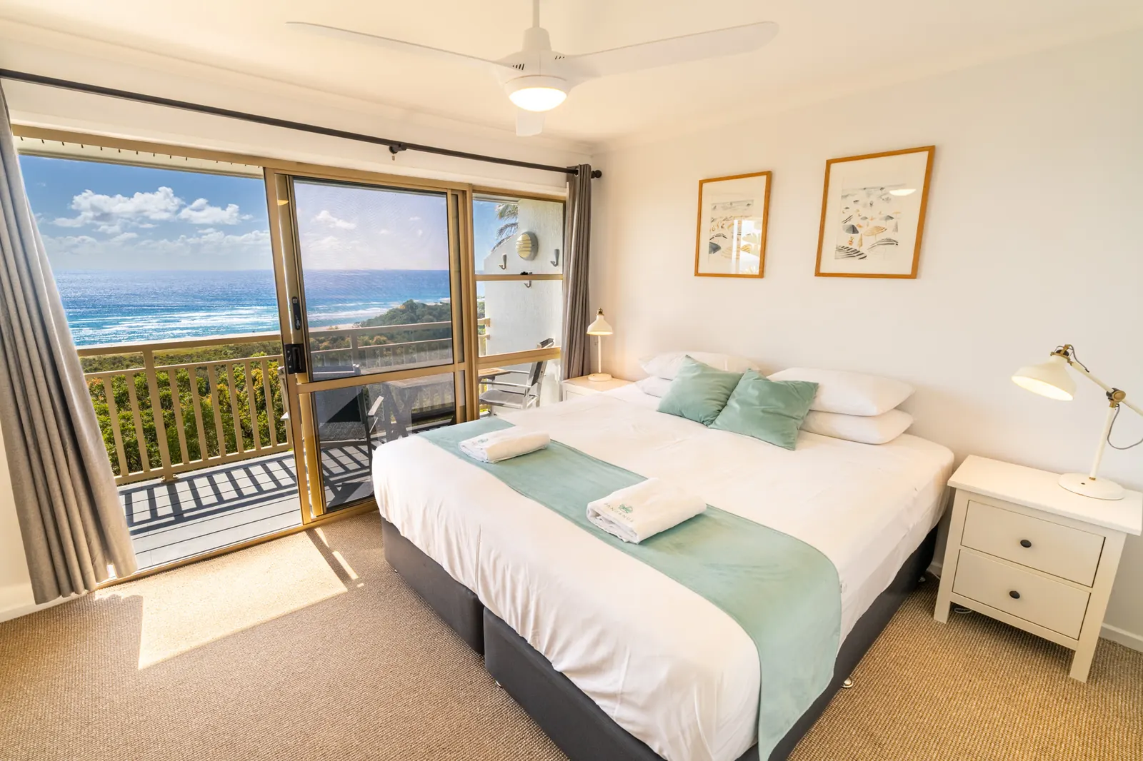 A bedroom inside a Premium Headland Ocean villa at Pandanus Palms Resort