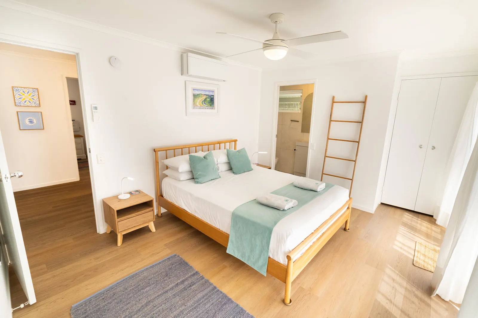 A bedroom inside a Prestige Headland Ocean 3 Bedroom villa at Pandanus Palms Resort
