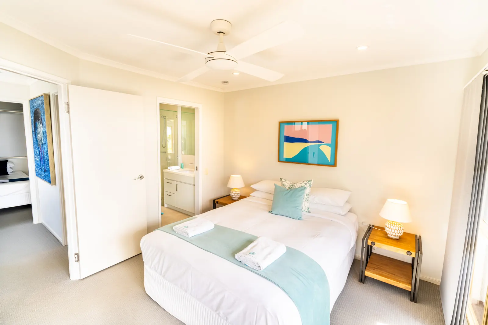 A bedroom inside a Prestige Headland Ocean 3 Bedroom villa at Pandanus Palms Resort